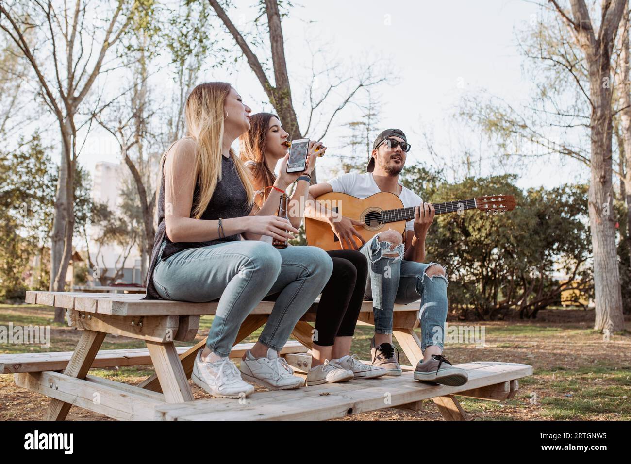 Cheerful musicians having fun in park Stock Photo