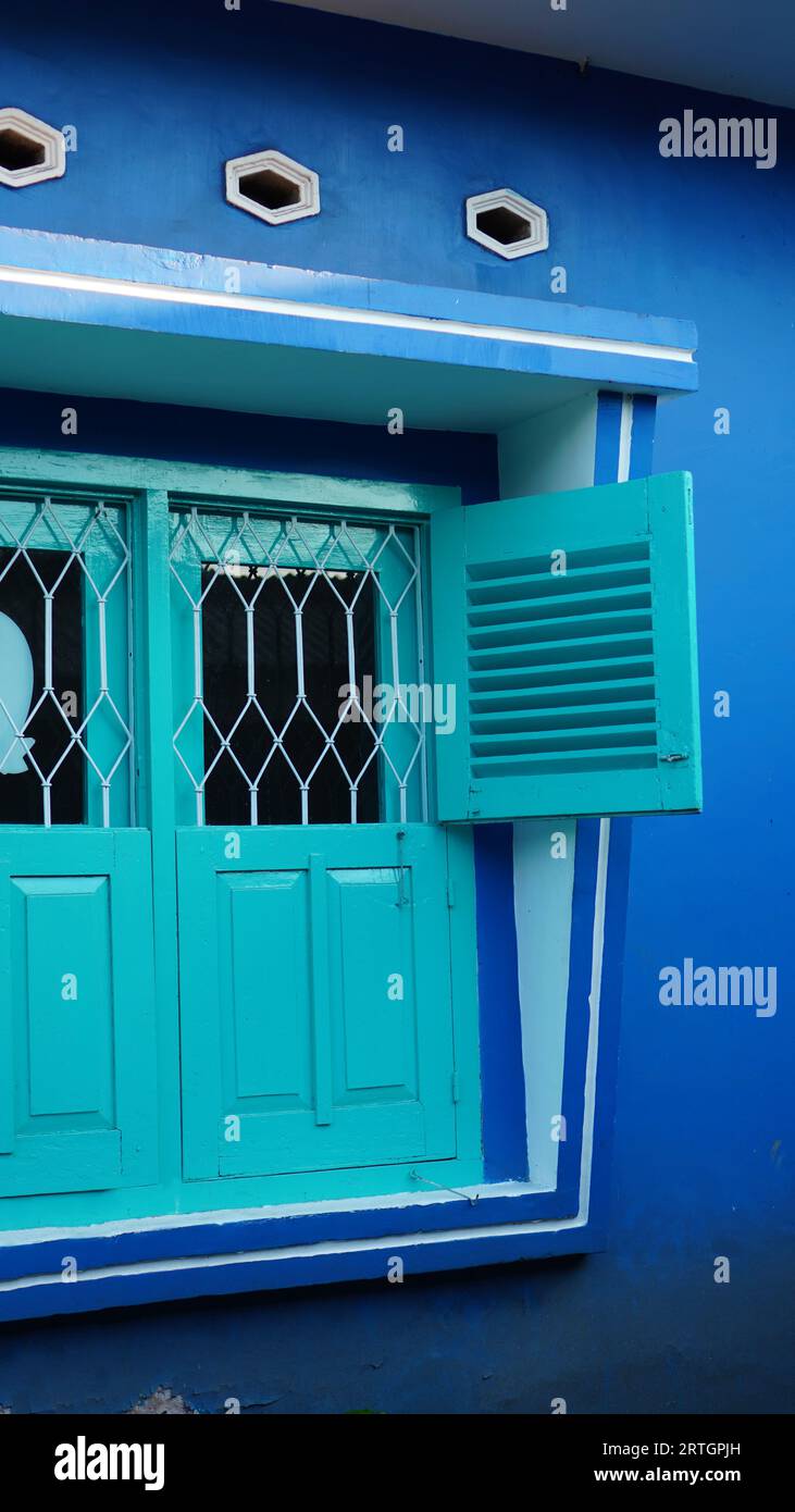 ancient windows are bright green with blue walls Stock Photo - Alamy