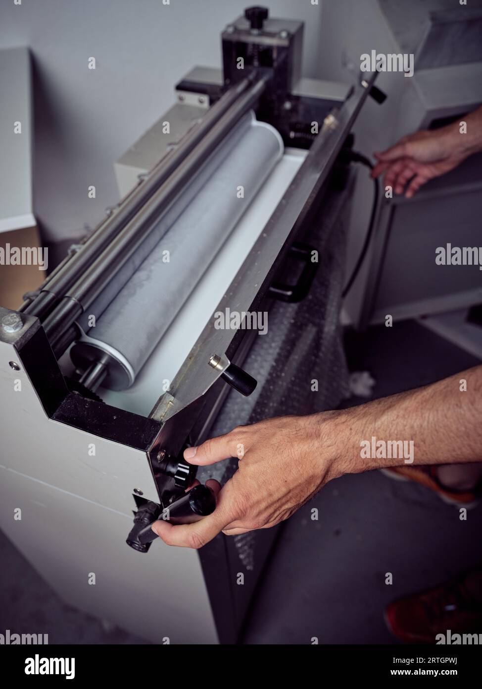 Crop unrecognizable male worker checking machine while using electric ...