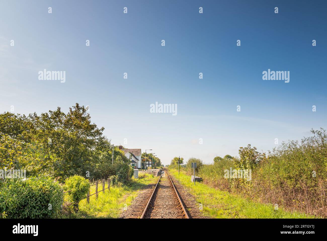 The single line railway track at the small Welsh village of Talsarnau, Gwynedd, which forms part of the transport for Wales railway system. Stock Photo