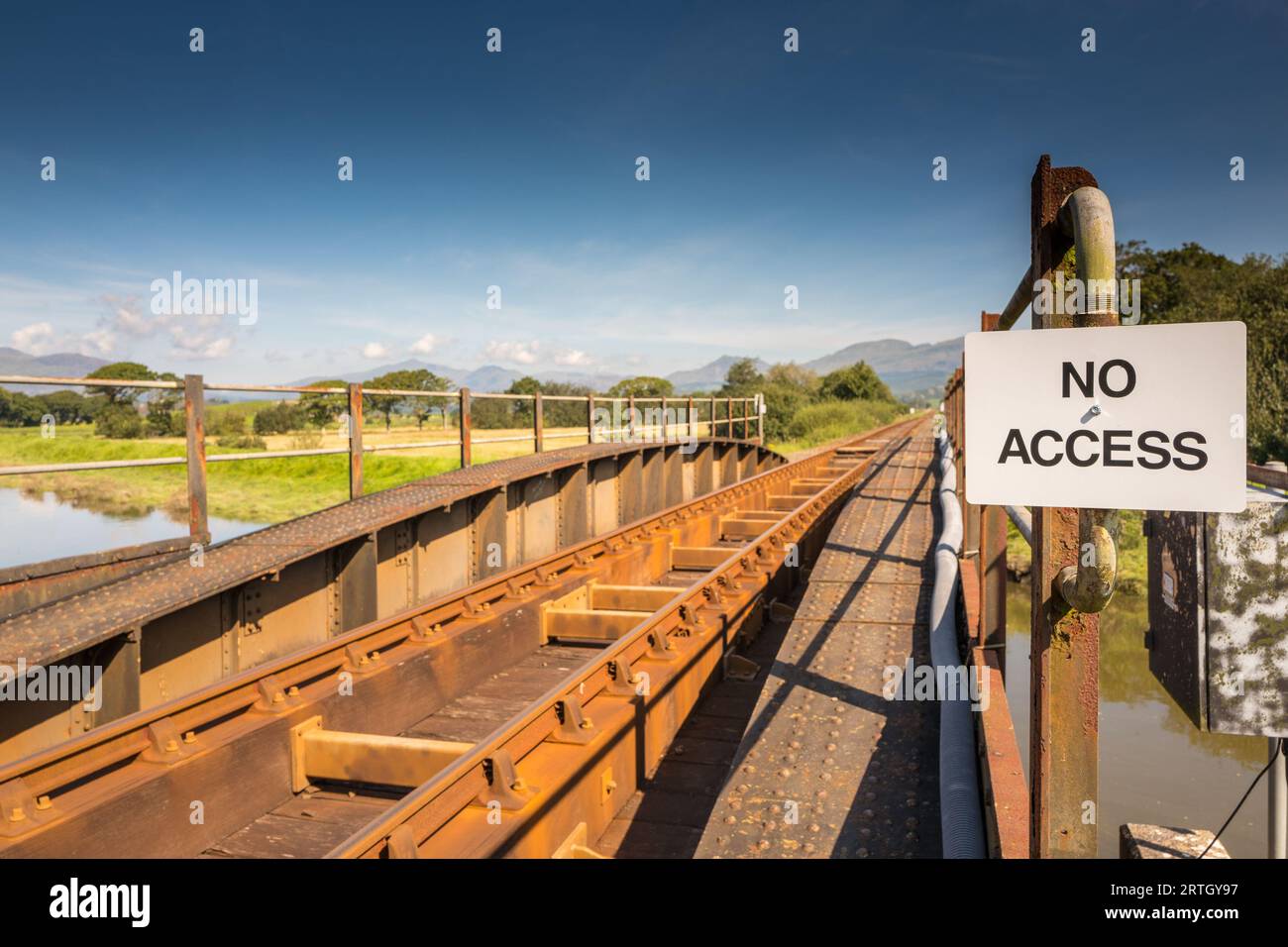 No Access sign attached to a iron single railway track bridge at Ynys in North Wales. Stock Photo