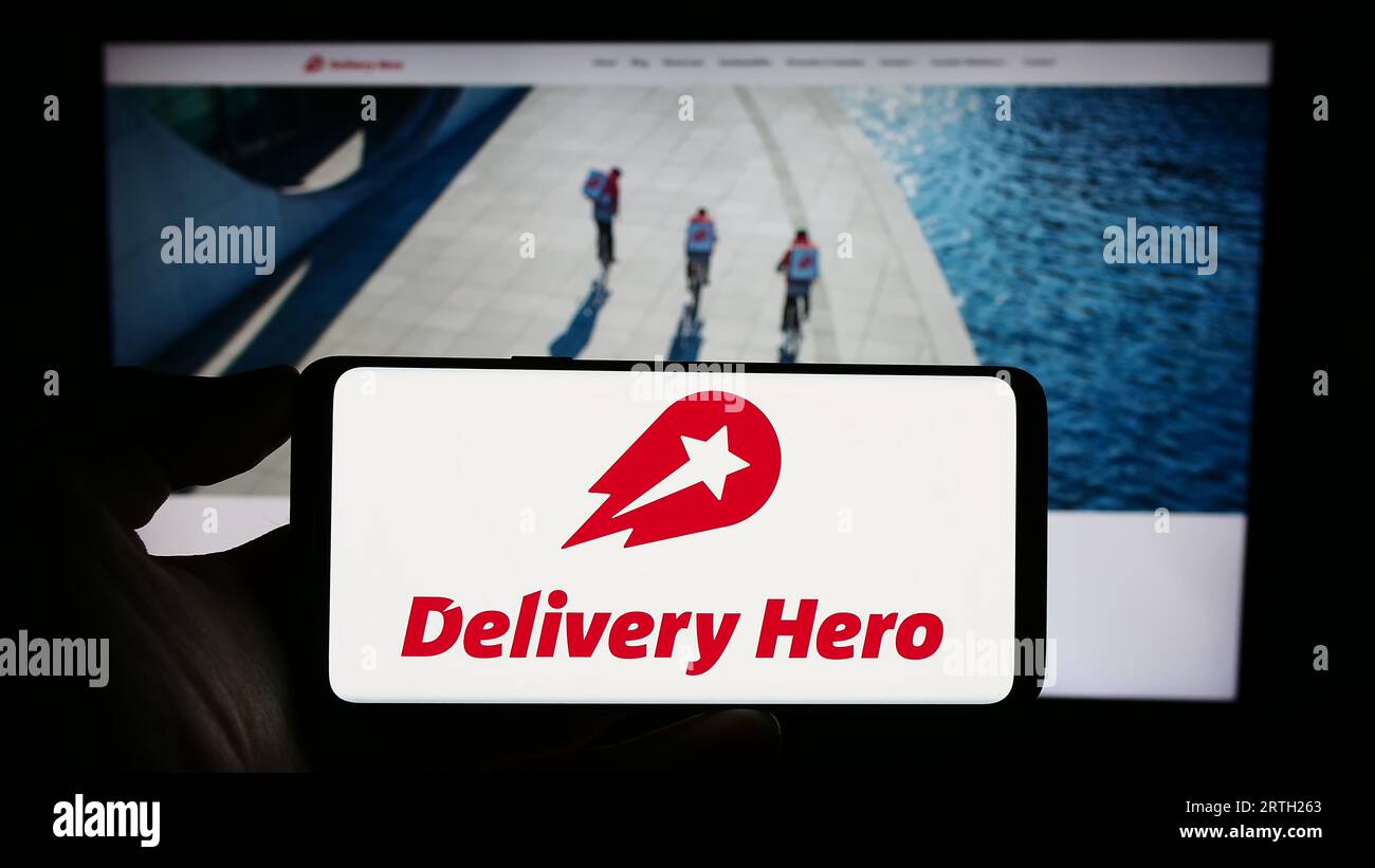 Person holding smartphone with logo of German food ordering company