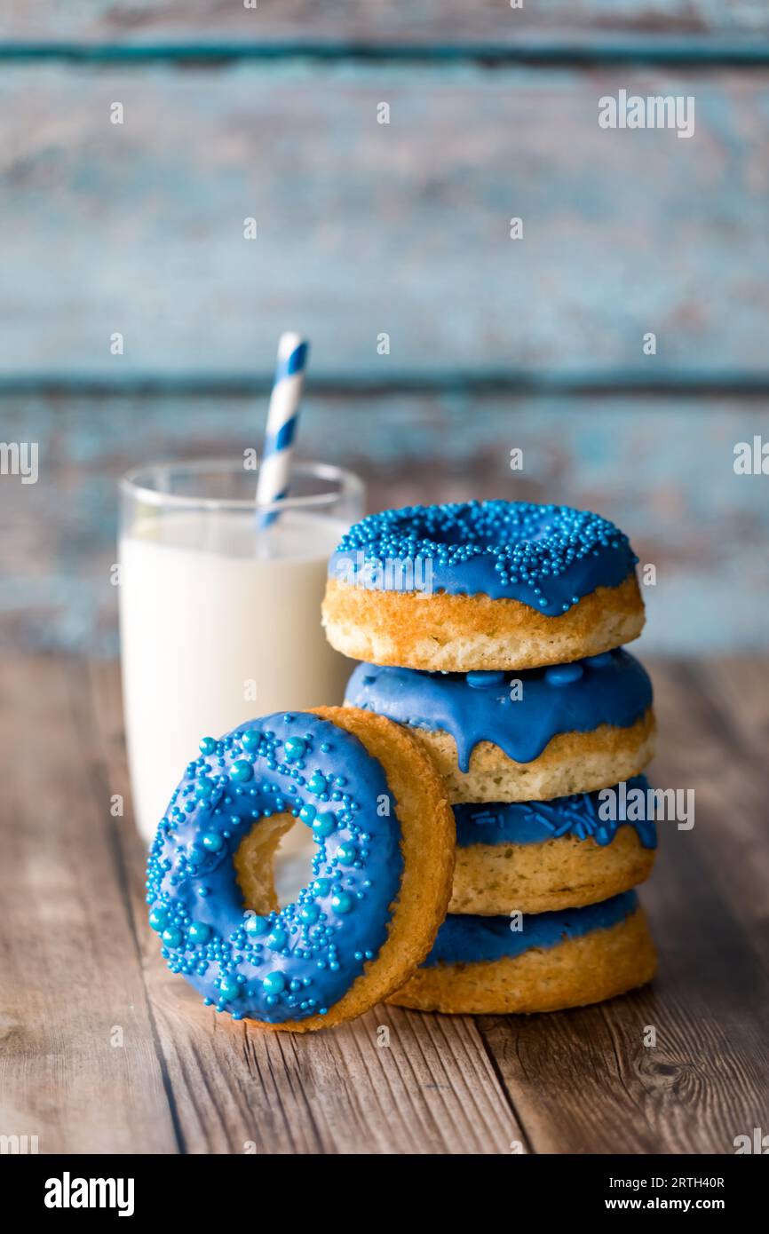 A stack of fresh homemade donuts with blue chocolate coating and ...