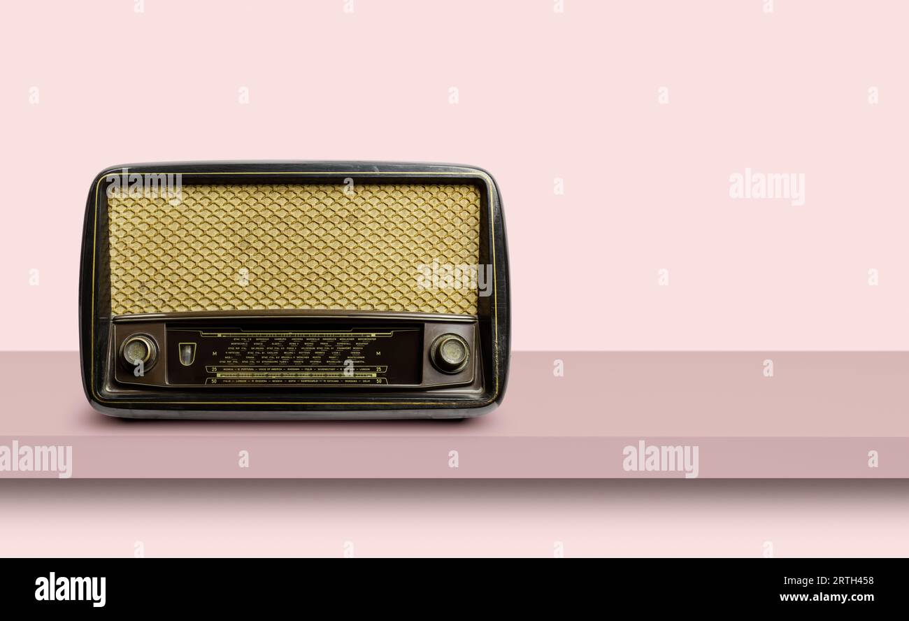 Antique radio on shelf with vintage background. Stock Photo