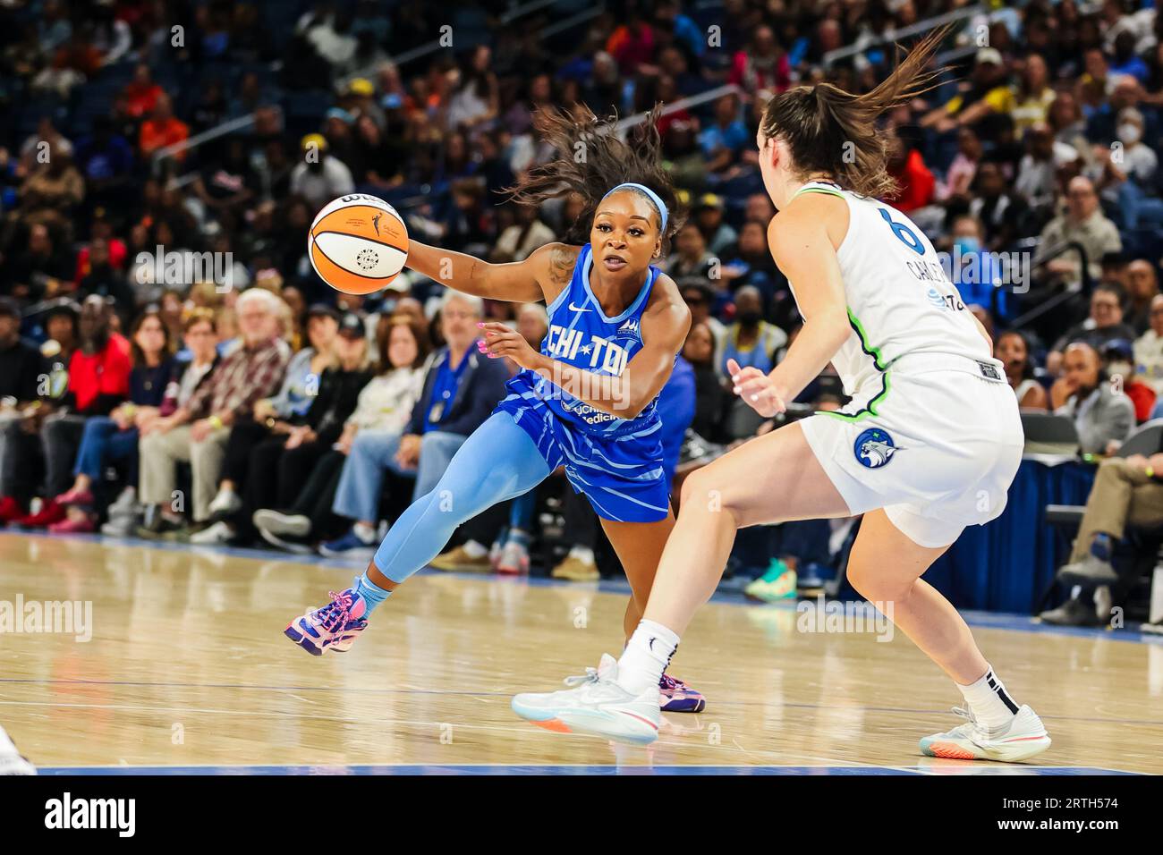 Dana Evans of the Chicago Sky dribbles around #6 of Minnesota Lynx in Chicago, IL at Wintrust Arena. Stock Photo