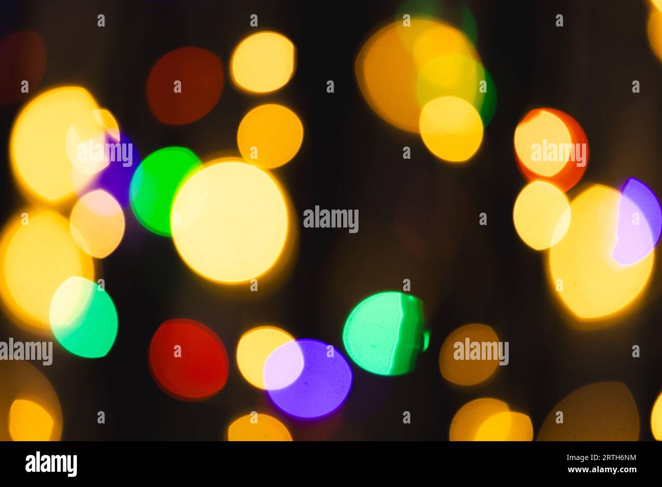 Multi coloured bokeh lights with copy space on dark background Stock Photo
