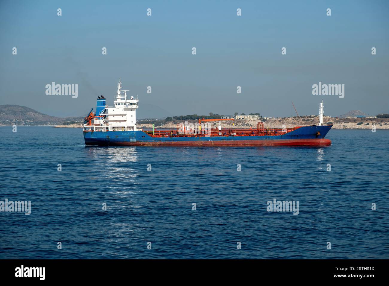Container cargo ship loaded leaves Piraeus port, Greece. Import export business and logistics. Commercial trade and transportation concept. Stock Photo