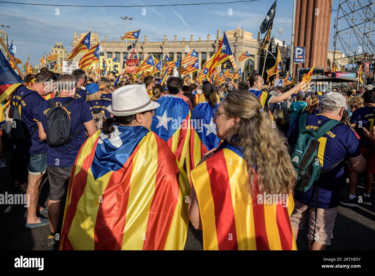 Barcelona, Catalonia, Spain - September 11, 2023: People participating and waving estelada flags in the demonstration for the independence of the Nati Stock Photo