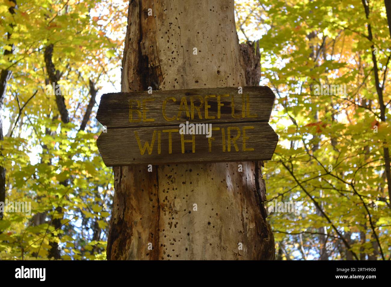 Fire danger sign on a fire damaged tree Stock Photo