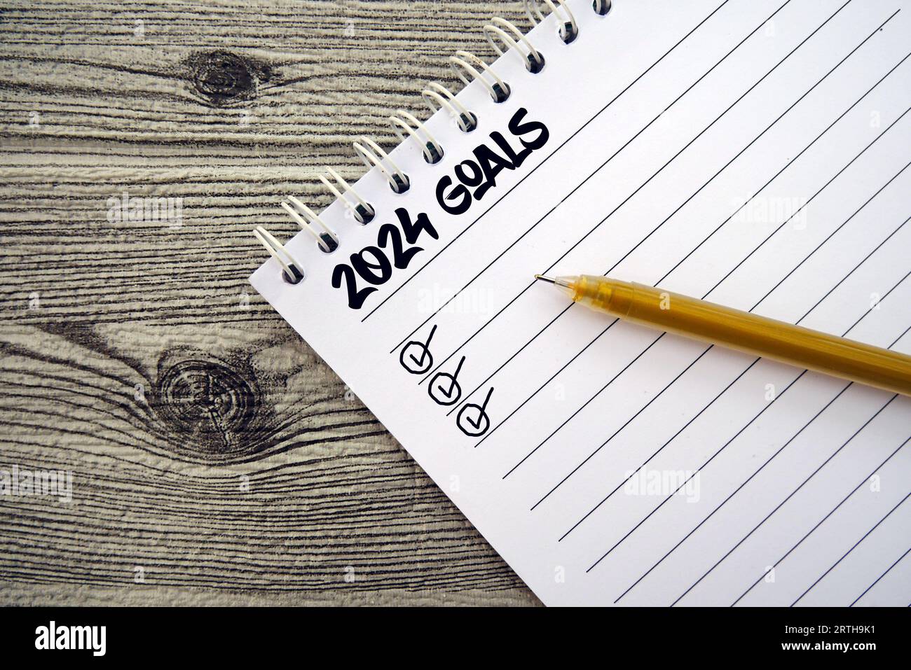 New year resolutions 2024. 2024 goals list with notebook on wooden