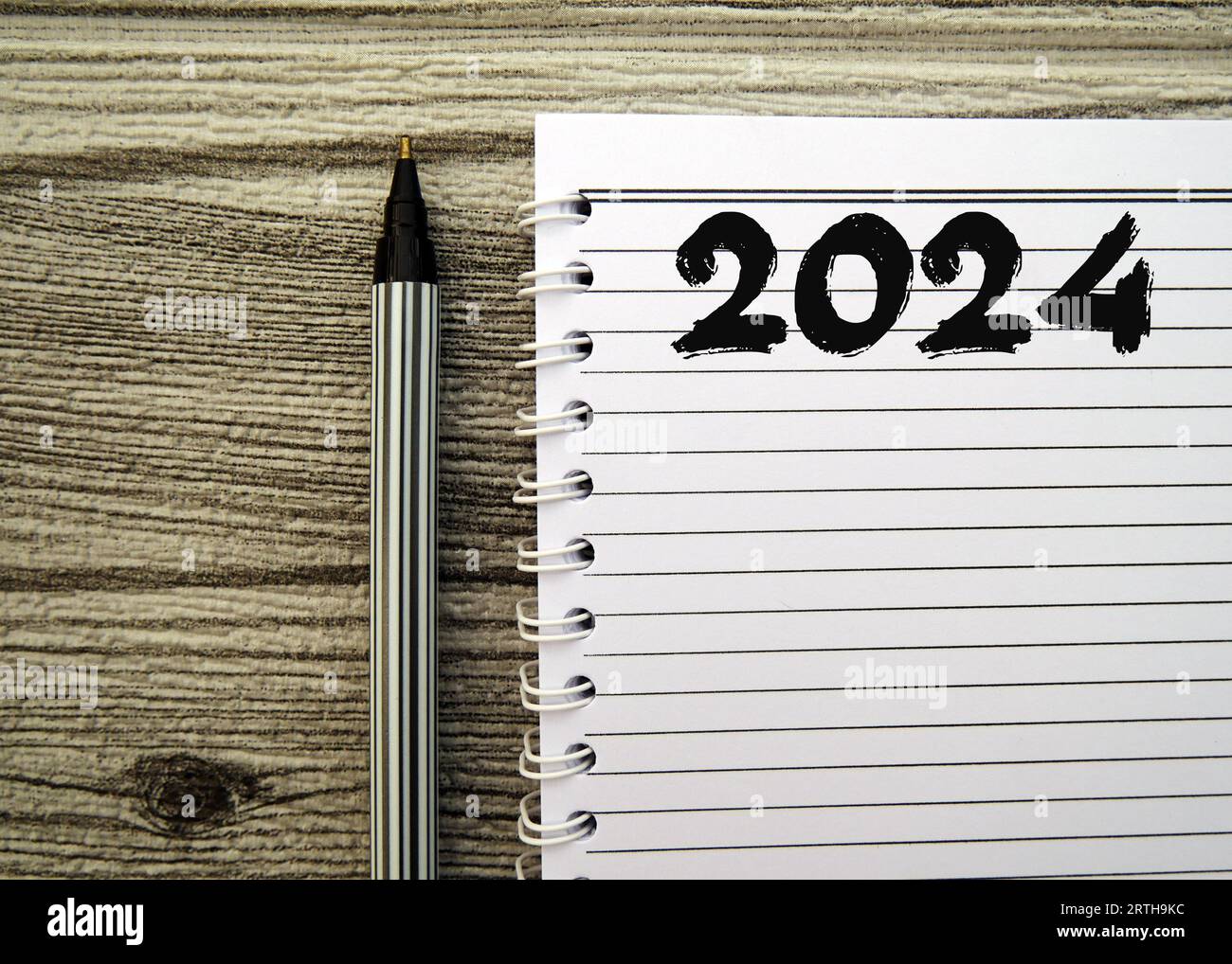 New year resolutions 2024. 2024 goals list with notebook on wooden