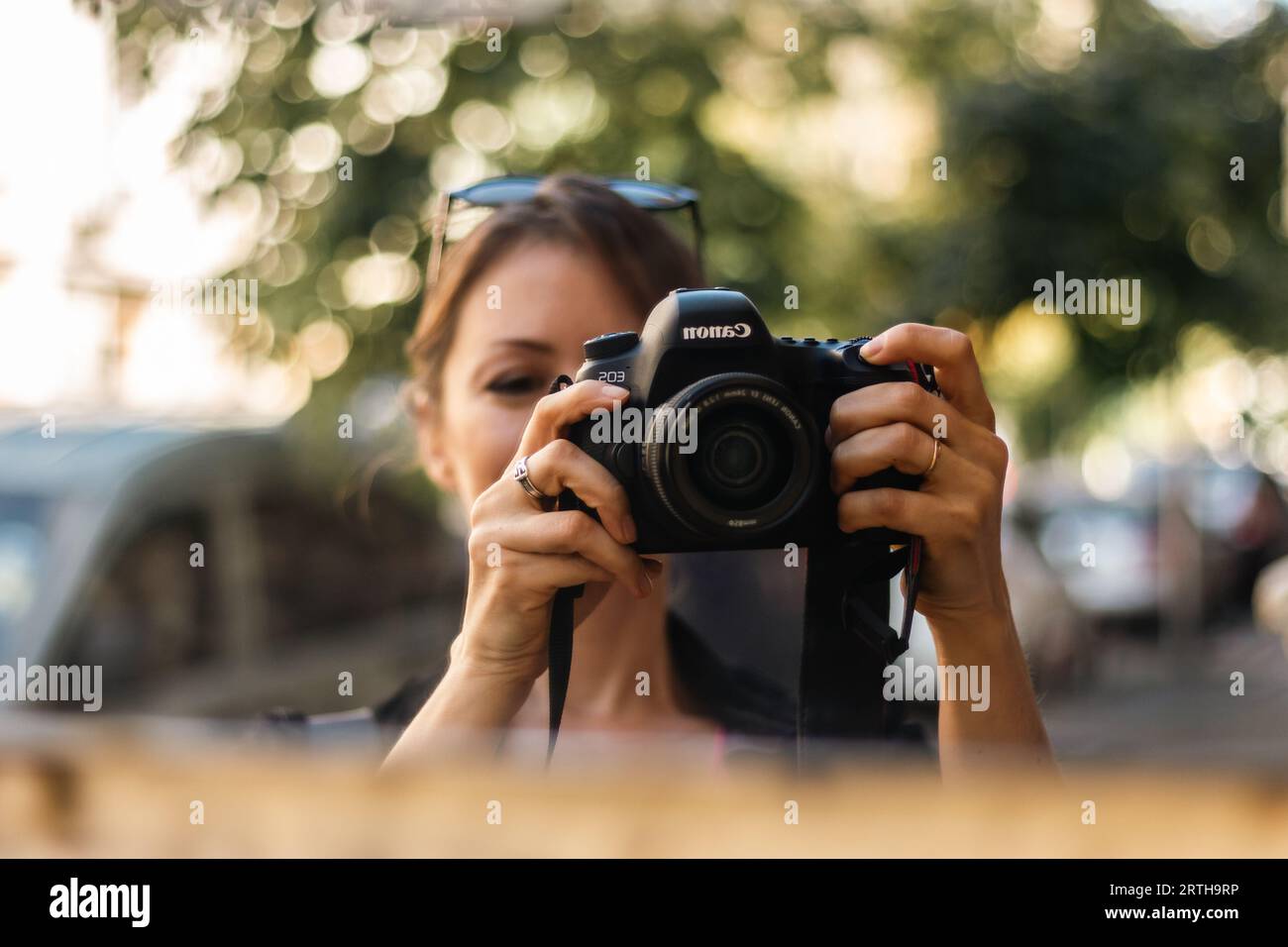 Woman taking photo canon camera hi-res stock photography and images