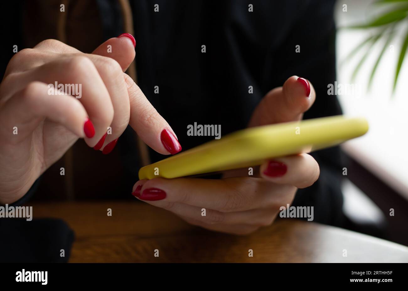 Woman uses a smartphone Stock Photo