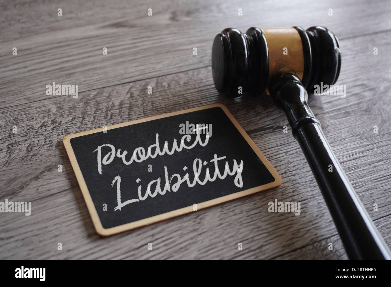 Closeup image of judge gavel and text PRODUCT LIABILITY on table. Stock Photo