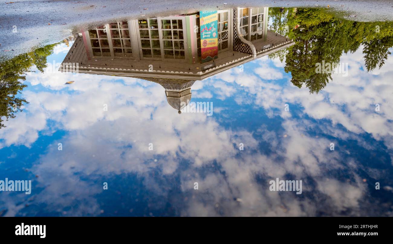 Sweet shop reflected in a large puddle in Strathpeffer, Scotland Stock Photo
