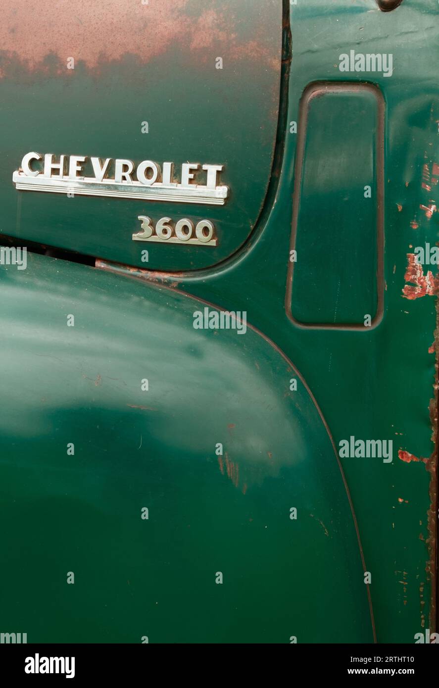 Side Of A Chevrolet With Worn Paint Of A 1950s Chevrolet Advance Design 3600 Truck, Lorry England UK With Badge Stock Photo