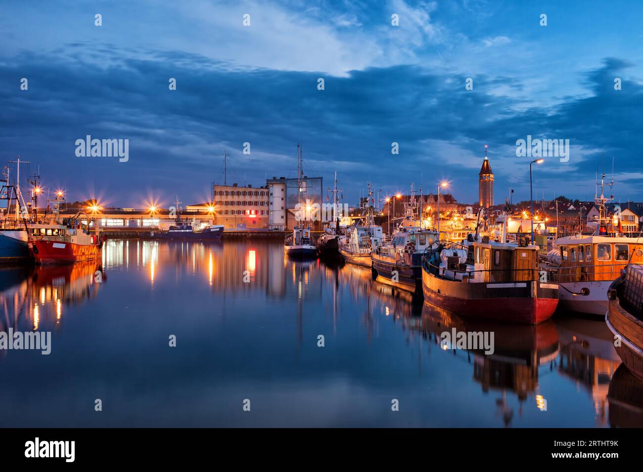 Port in Wladyslawowo town in Poland at night, fishing ships and boats and city skyline Stock Photo