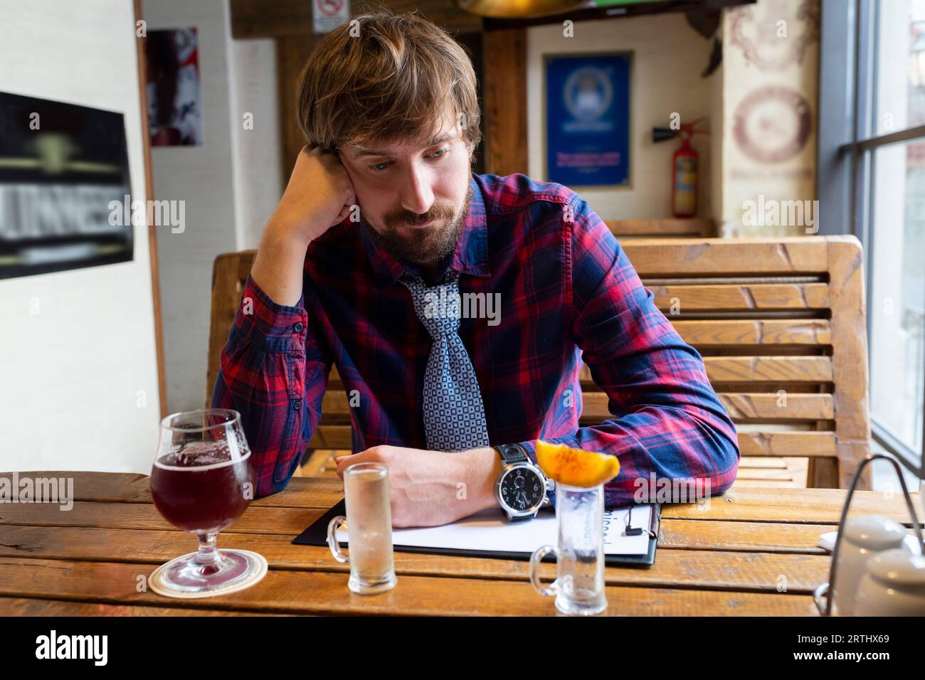 Sad lonely young man sits hi-res stock photography and images - Alamy