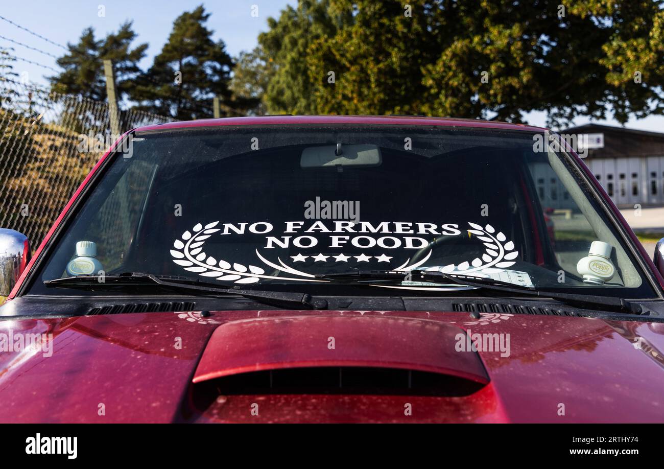 Signs and symbols, a car with a sticker on the windshield, with the text: No farmers, no food'. Stock Photo
