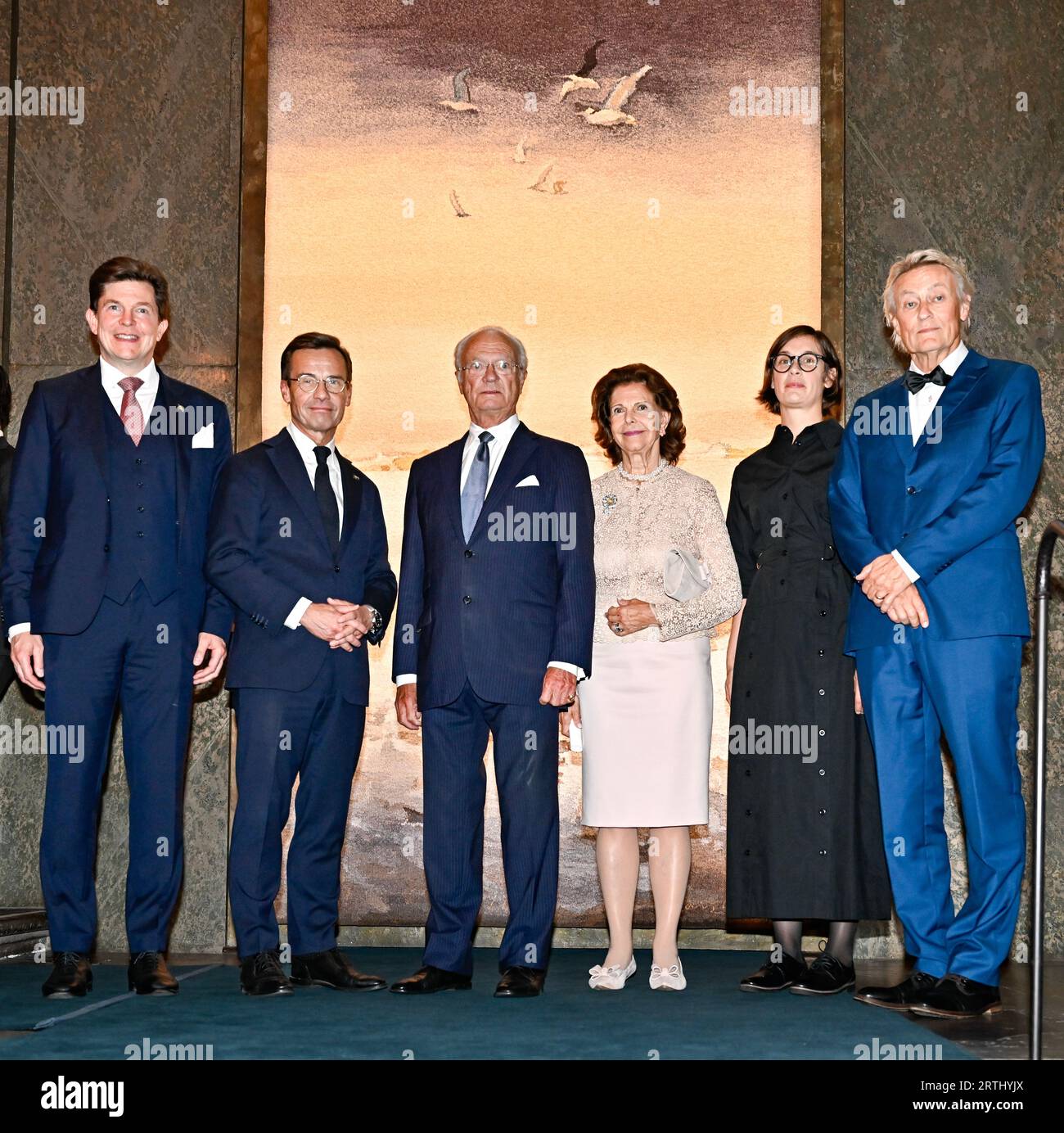 STOCKHOLM 20230913 (L-R) Parliament Speaker Andreas Norlén, Prime Minister Ulf Kristersson, King Carl Gustaf, Queen Silvia, artists Frida Lindberg and Lars Lerin, at a reception at the Royal Palace in Stockholm where a gift from the parliament and government was handed over to the King, who celebrates 50 years on the throne. The gift is an eight-square meter fabric made after a watercolor painting by Swedish artist Lars Lerin. Frida Lindberg has been artistic director and weavers have been Ebba Bergström and Tova Vibrandt. Photo: Jonas Ekstromer/TT/code 10030 Stock Photo