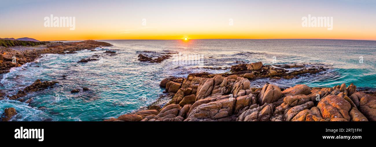 The sun rises over Friendly Beaches in Freycinet national park on Tasmanias east coast Stock Photo