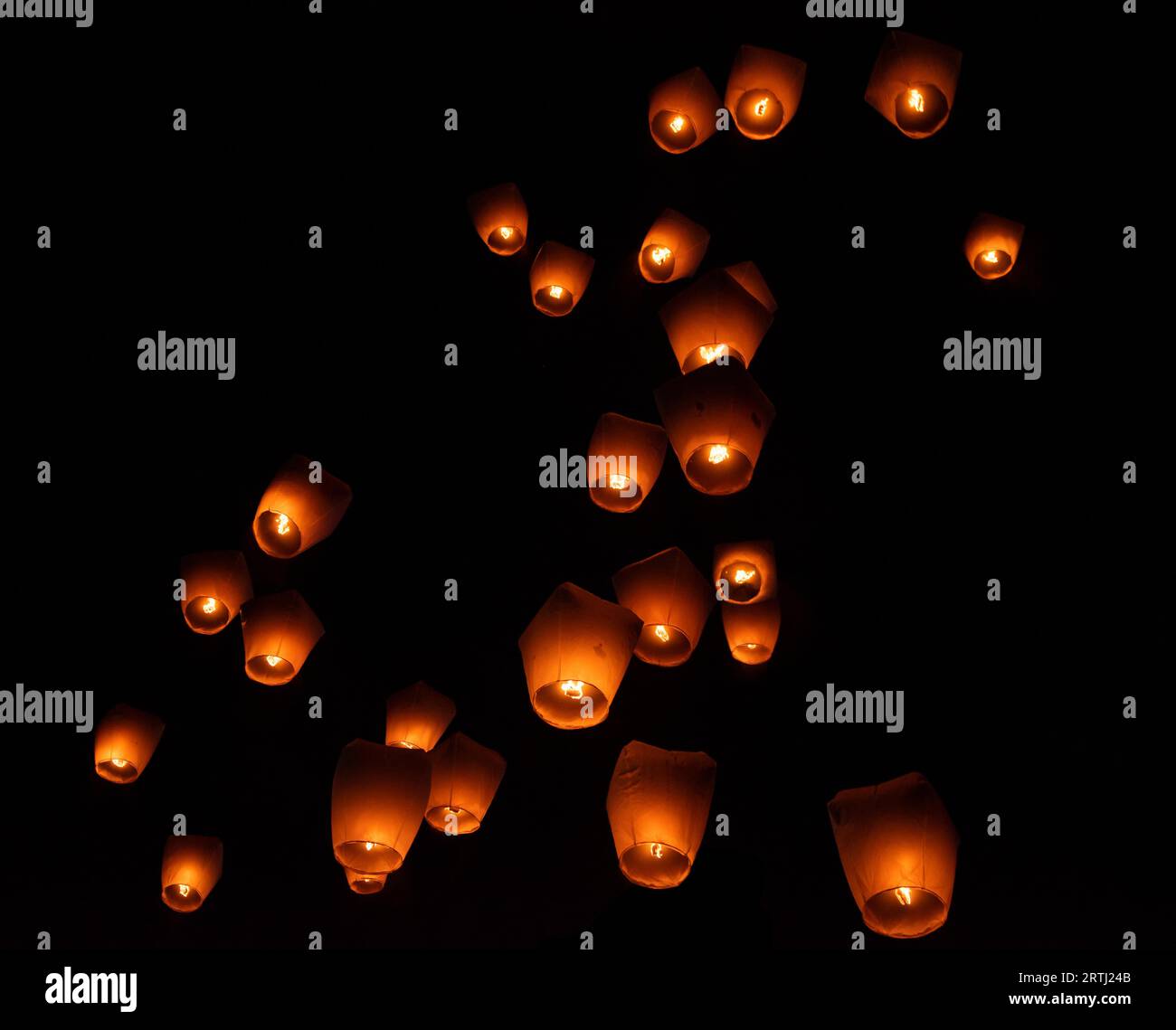 Glowing paper lanterns illuminate the night sky during the Pingxi sky lantern festival in Taiwan Stock Photo