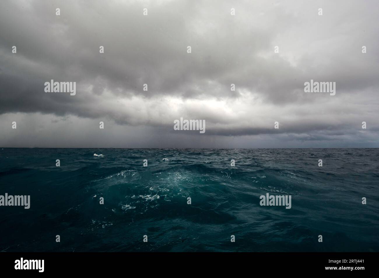 Tropical storm Growing typhoon due to climate change Storm with dark clouds over agitated sea, Pacific Ocean Stock Photo