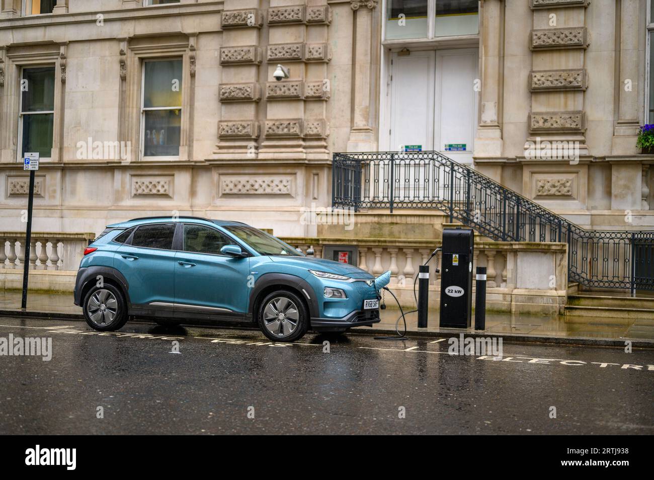 LONDON April 24, 2023 An electric car charges on a wet London street