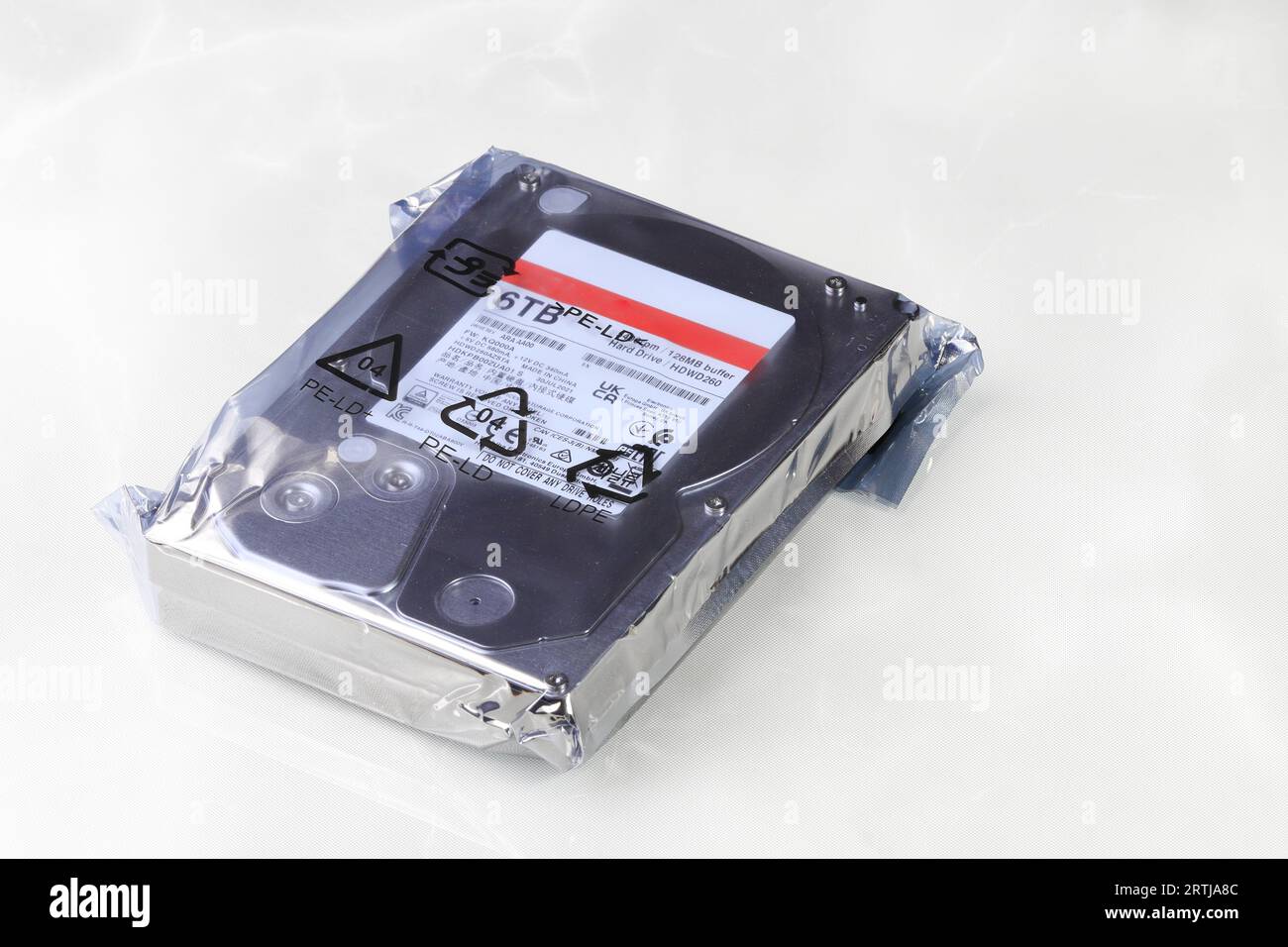 Close up view of high capacity computer hard drive 3.5" in LDPE Packaging isolated on white background. Stock Photo