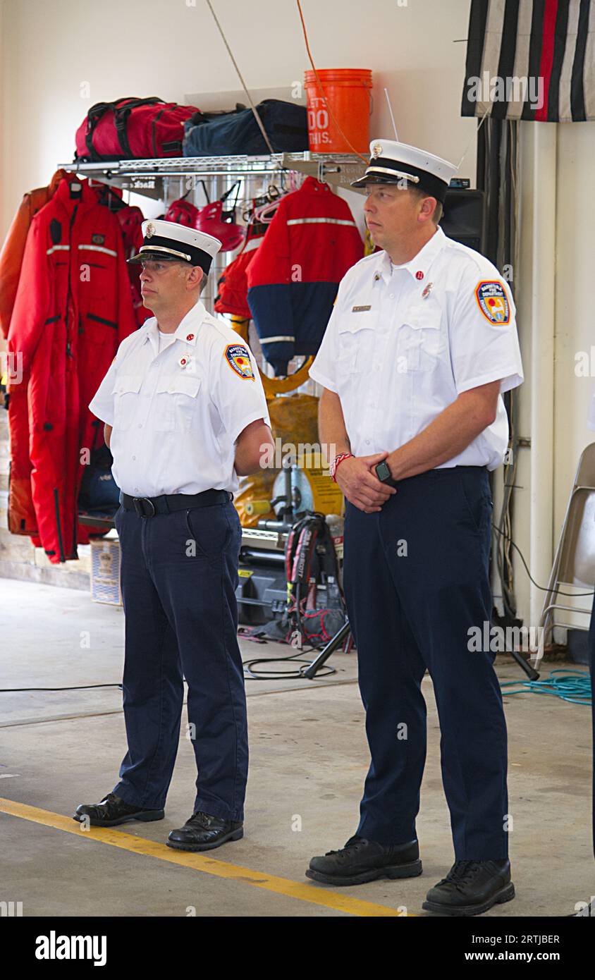 911 commemoration ceremony at Barnstable, MA Fire Headquarters on Cape Cod, USA., Fire Dept Officers at attention Stock Photo