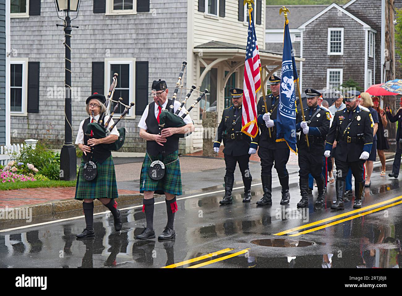 911 commemoration ceremony at Barnstable, MA Fire Headquarters on Cape Cod, USA. The procession marches though the Village. Stock Photo