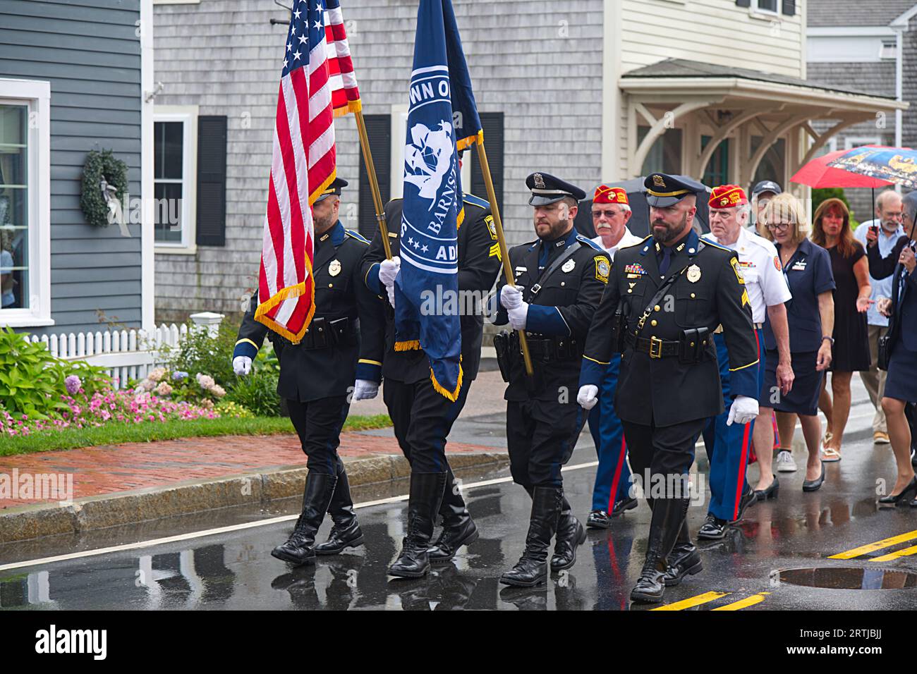 911 commemoration ceremony at Barnstable, MA Fire Headquarters on Cape Cod, USA. The procession marches though the Village. Stock Photo