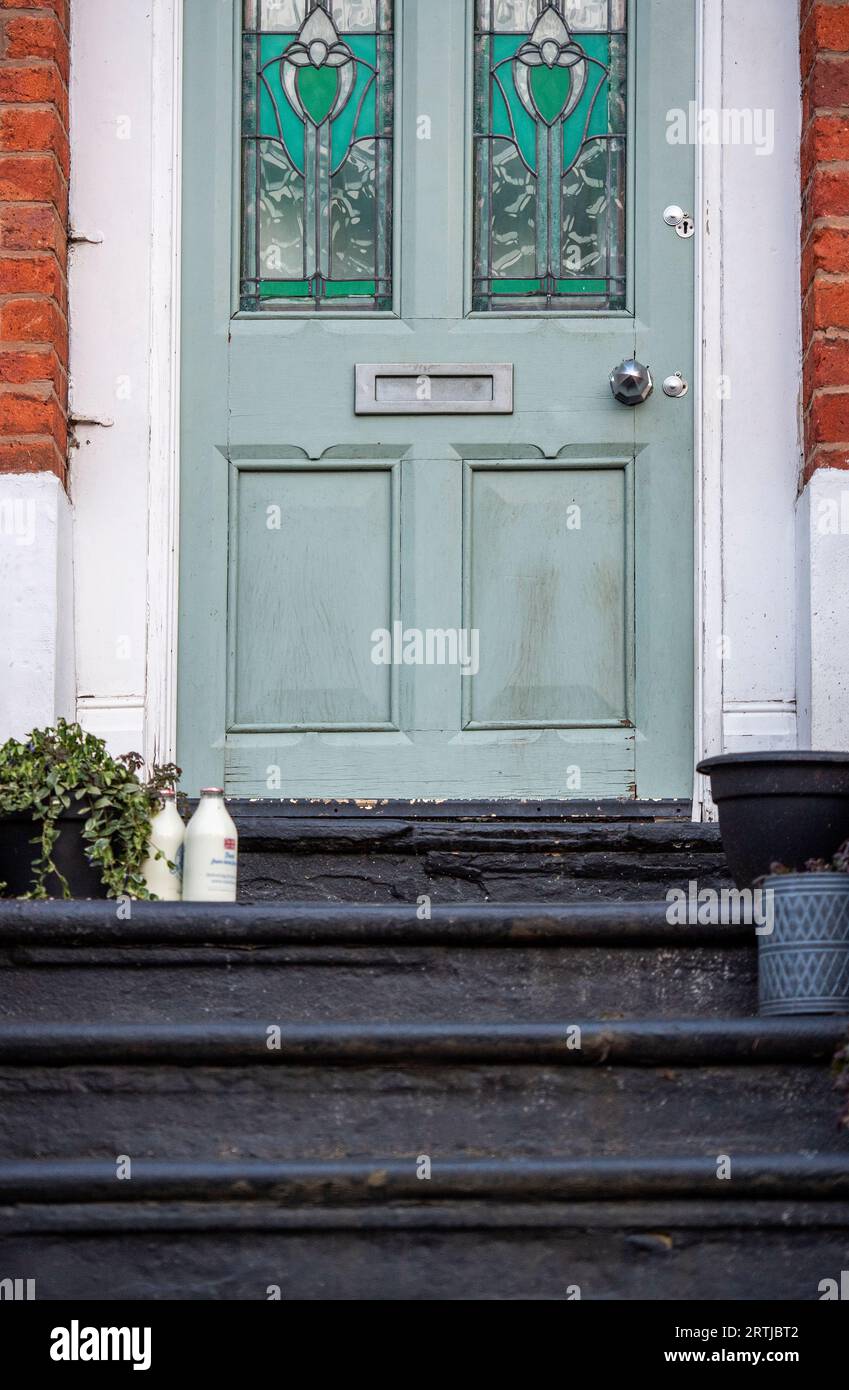 Milk bottles on the doorstep of a house in Manchester, England, UK Stock Photo
