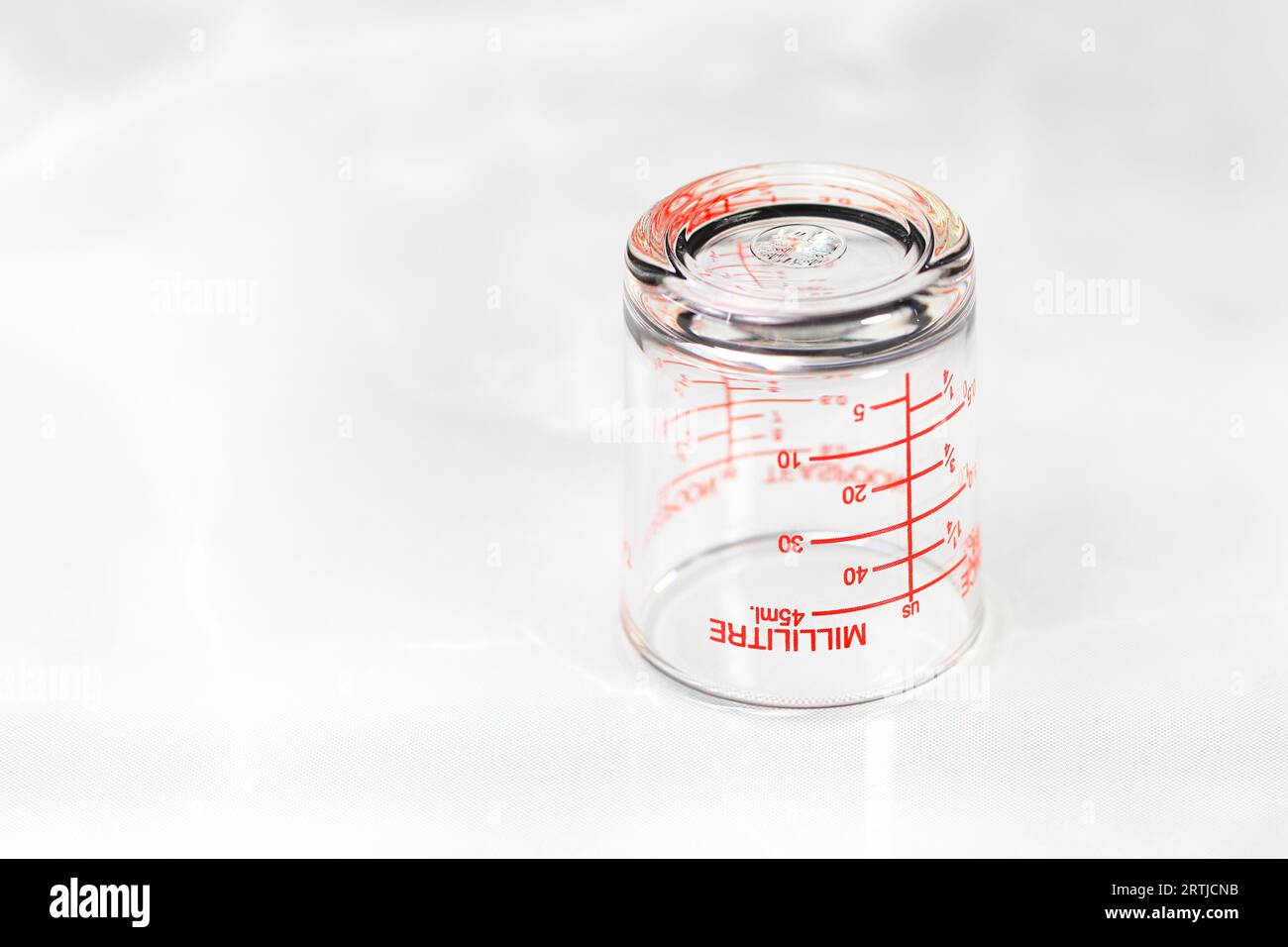 https://c8.alamy.com/comp/2RTJCNB/inverted-glass-measuring-cup-or-dosage-cup-with-milliliter-measurements-displayed-2RTJCNB.jpg