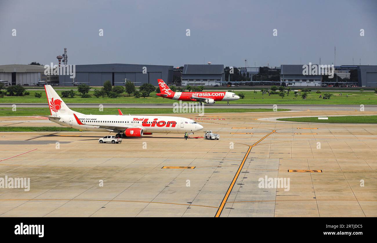 Aircraft push back by airplane Tugs to taxiway, one in ground handling services. Stock Photo