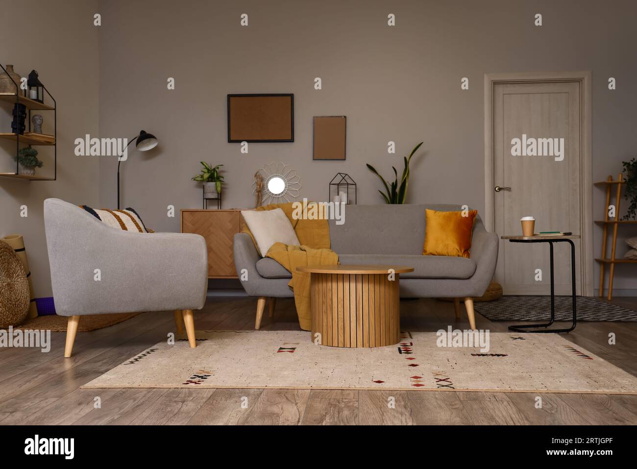 Interior of modern living room with sofa and armchair Stock Photo - Alamy