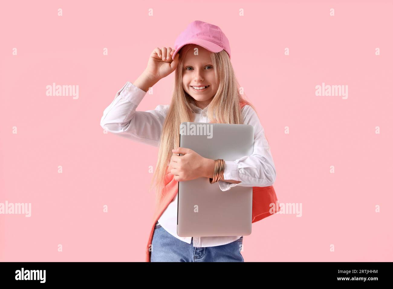 Little girl with laptop on pink background Stock Photo - Alamy