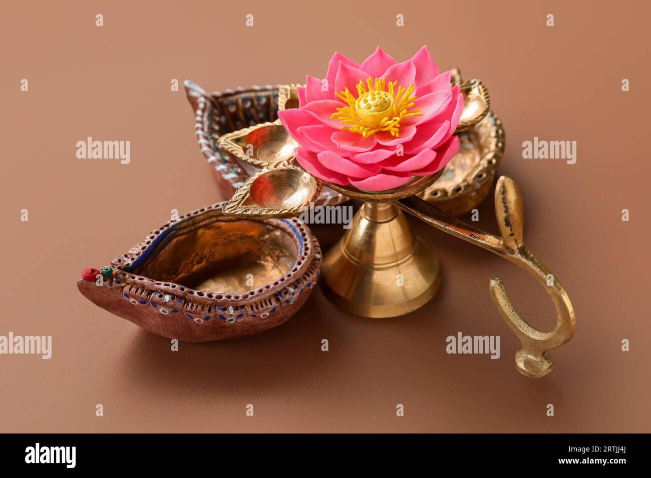 Diya lamps with lotus flower for celebration of Divaly on brown background Stock Photo