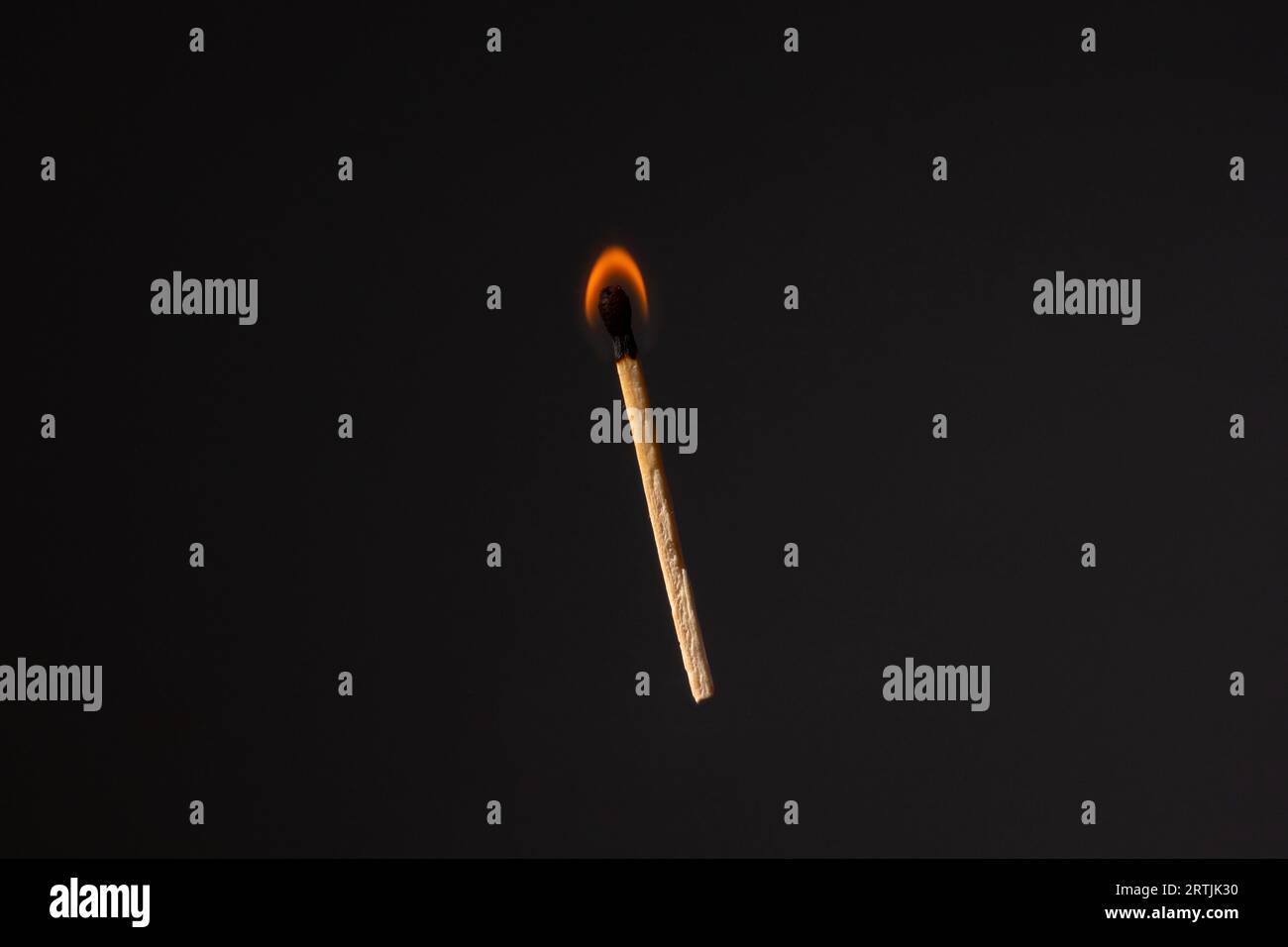 Lit and falling match on a black background. Stock Photo