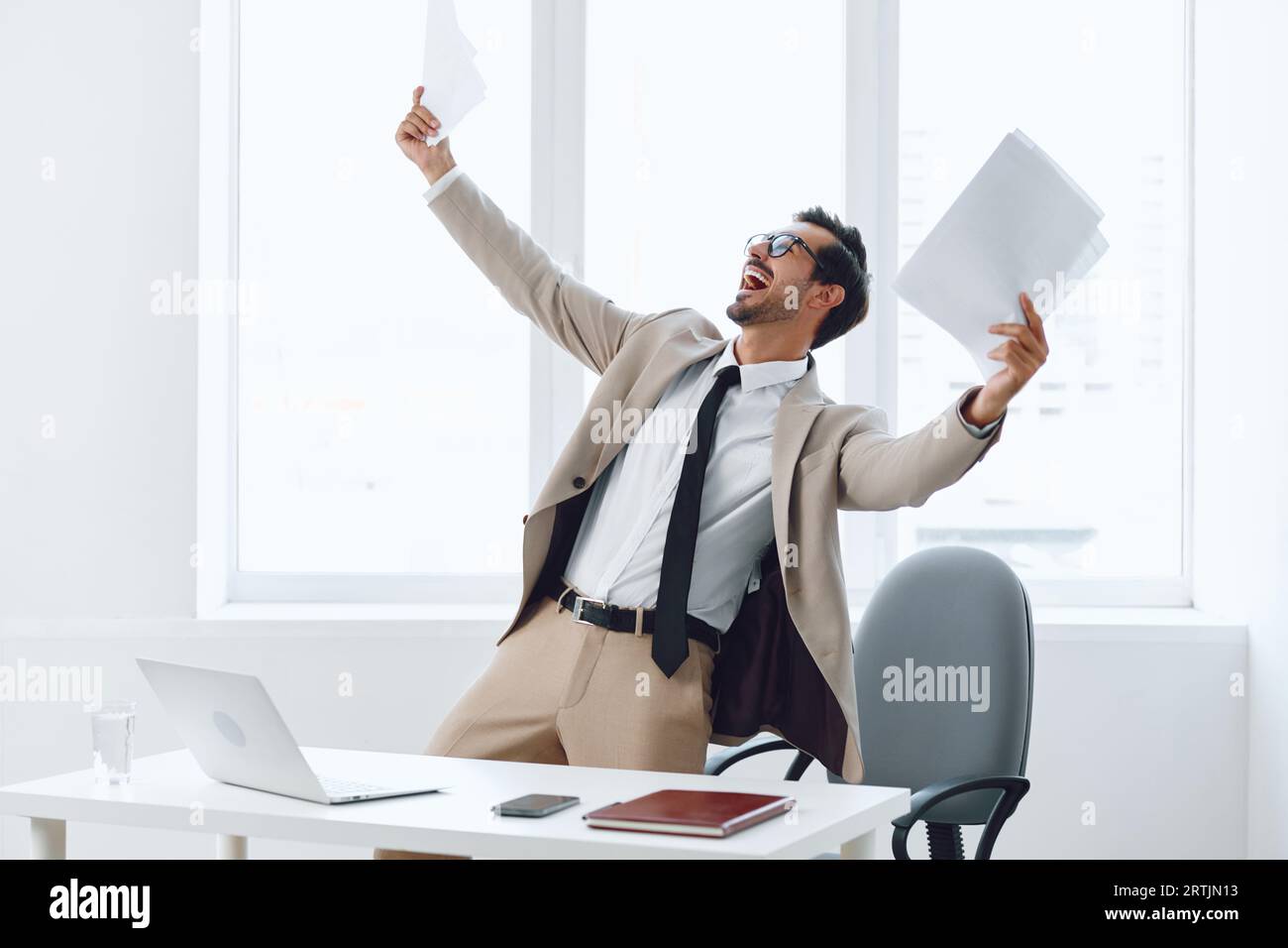 Paper planning holding happy businessman Stock Photo - Alamy