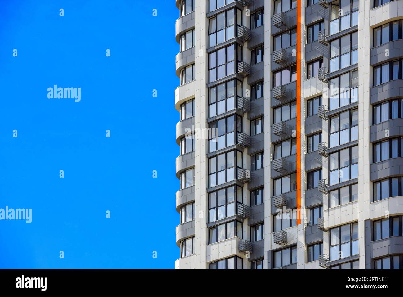 freshly built high rise apartment building on blue sky background Stock ...