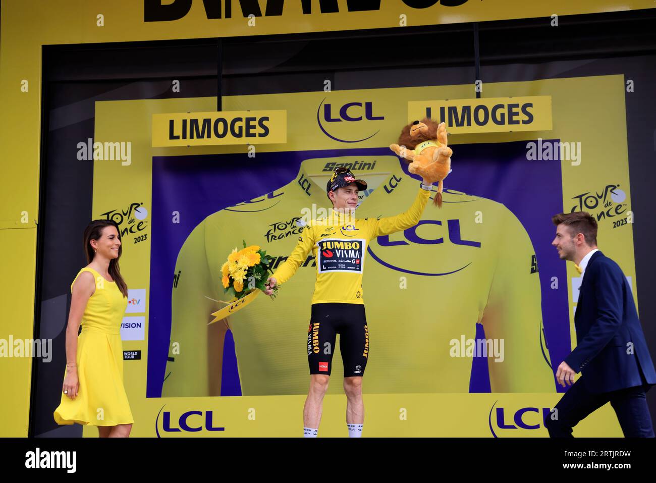 Jonas Vingegaard yellow jersey at the finish of the 8th Libourne Limoges stage of the 2023 cycling Tour de France. Climbing onto the podium in Limoges Stock Photo