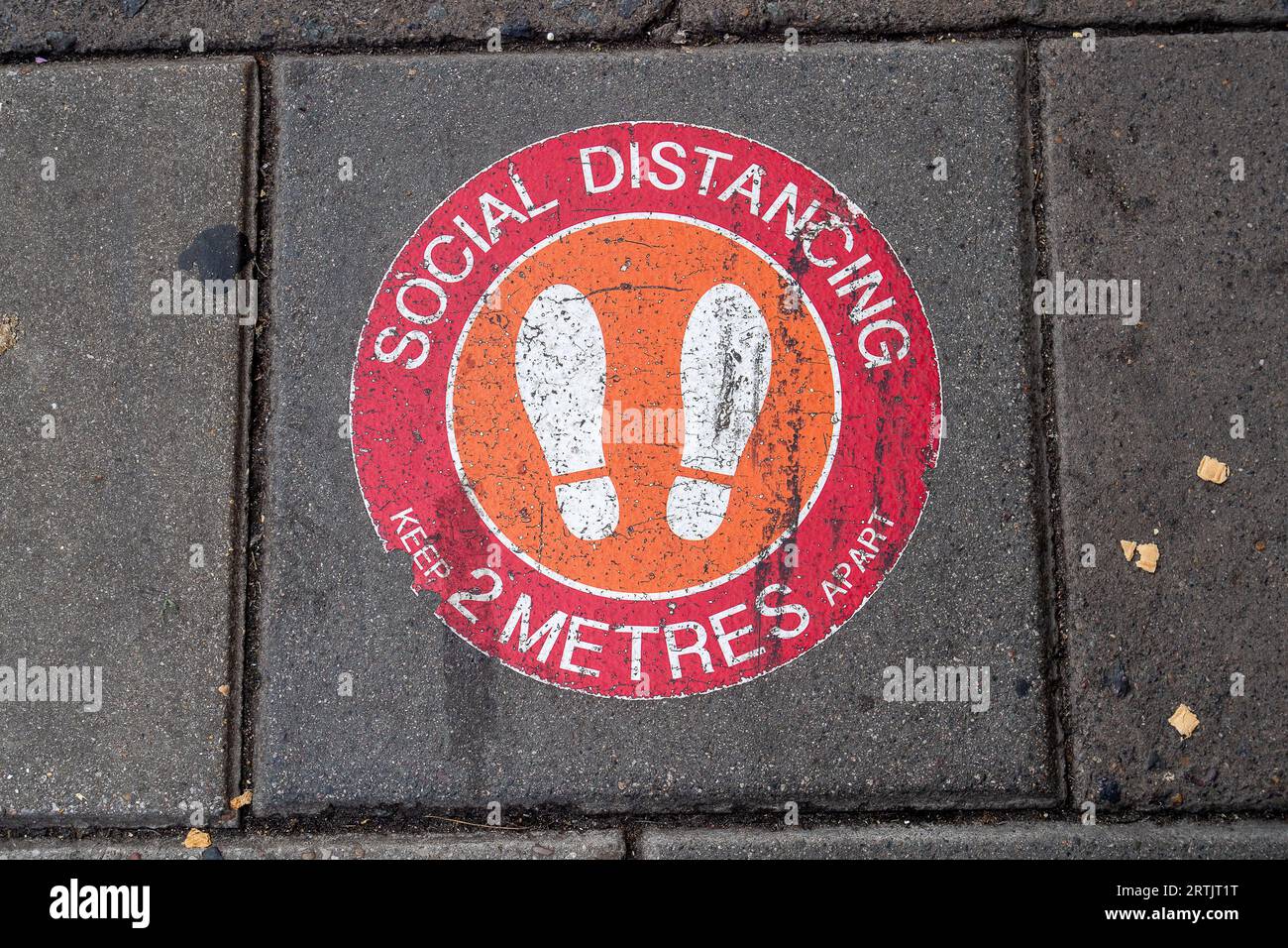 Windsor, Berkshire, UK. 2nd September, 2023. A legacy Social Distancing sign on a pavement in Windsor, Berkshire. A new Covid-19 variant BA.2.86 known as Pirola is said to be spreading in the UK. Credit: Maureen McLean/Alamy Stock Photo