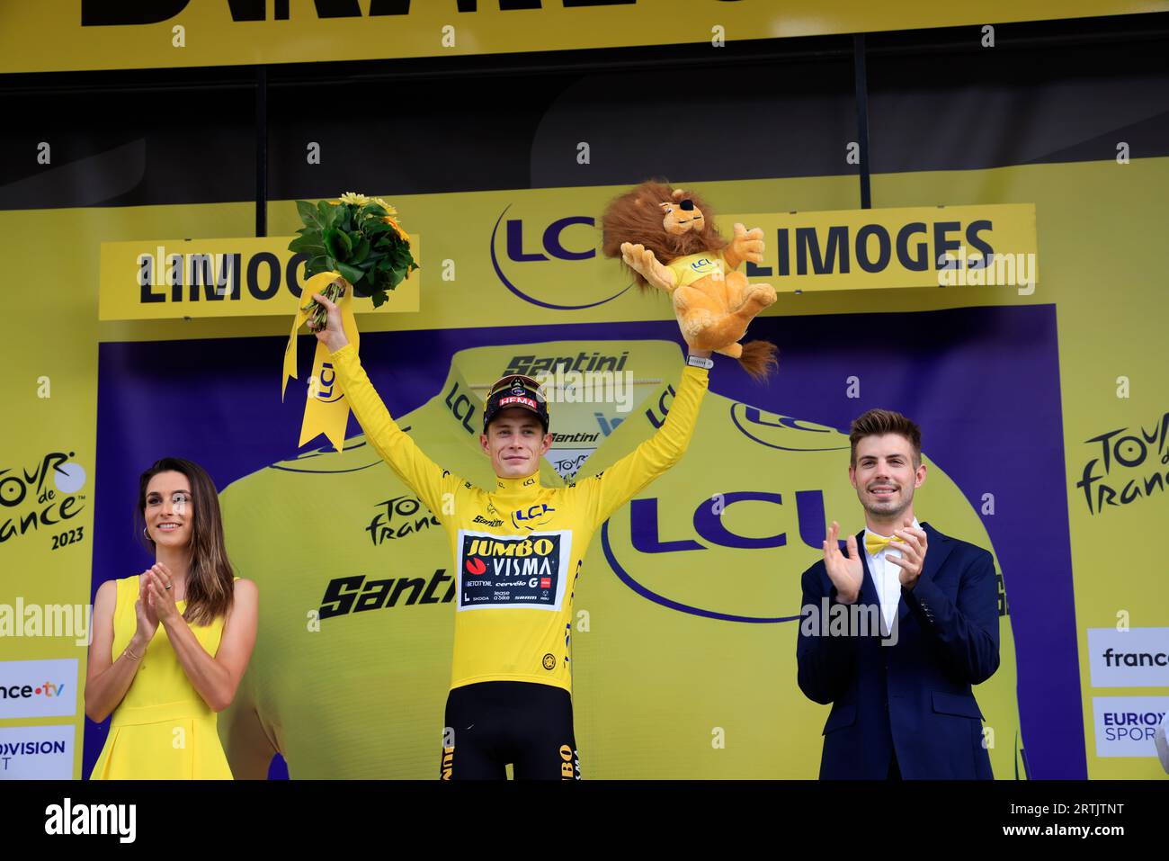 Jonas Vingegaard yellow jersey at the finish of the 8th Libourne Limoges stage of the 2023 cycling Tour de France. Climbing onto the podium in Limoges Stock Photo
