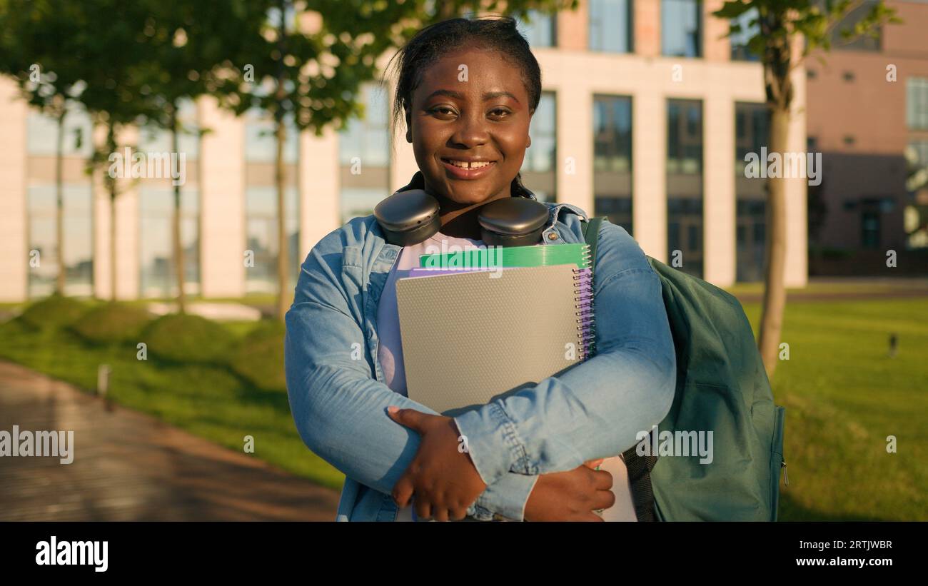 Portrait African American woman schoolgirl teen study university college campus academy student teenager girl high school education holding books Stock Photo