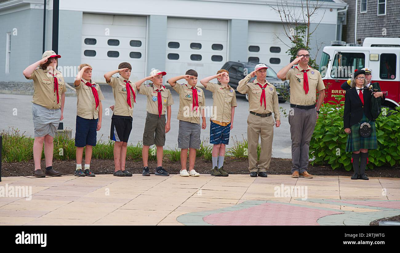 911 commemoration ceremony at Brewster, MA Fire Headquarters on Cape Cod, USA. Boy Scouts standing at attention, saluting!.. Stock Photo