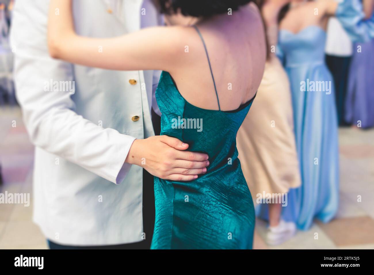 High school graduates dancing waltz and classical ball dance in dresses ...