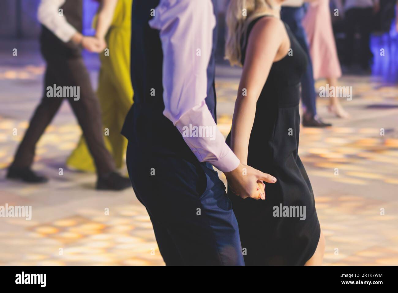 High school graduates dancing waltz and classical ball dance in dresses
