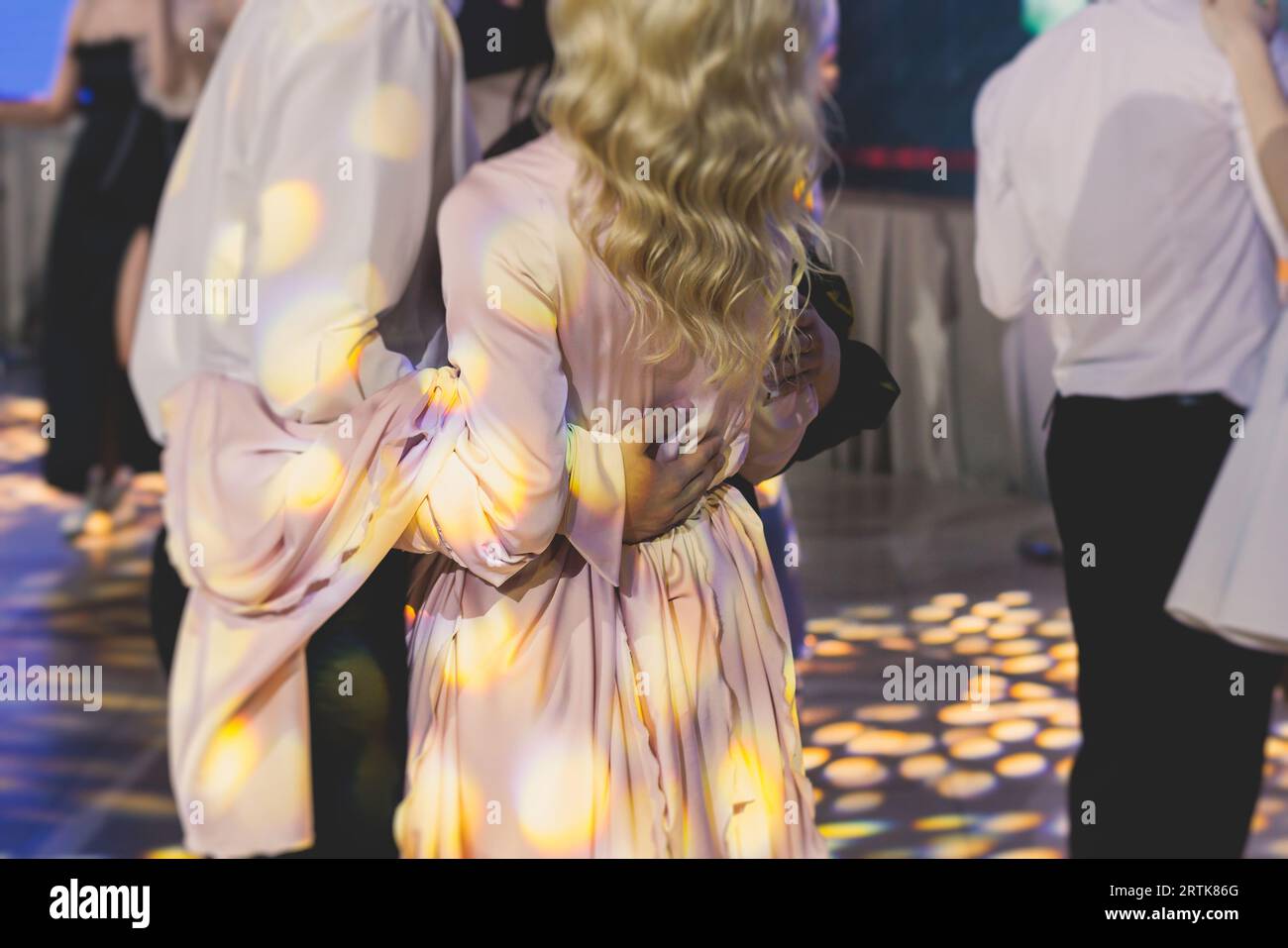 High school graduates dancing waltz and classical ball dance in dresses