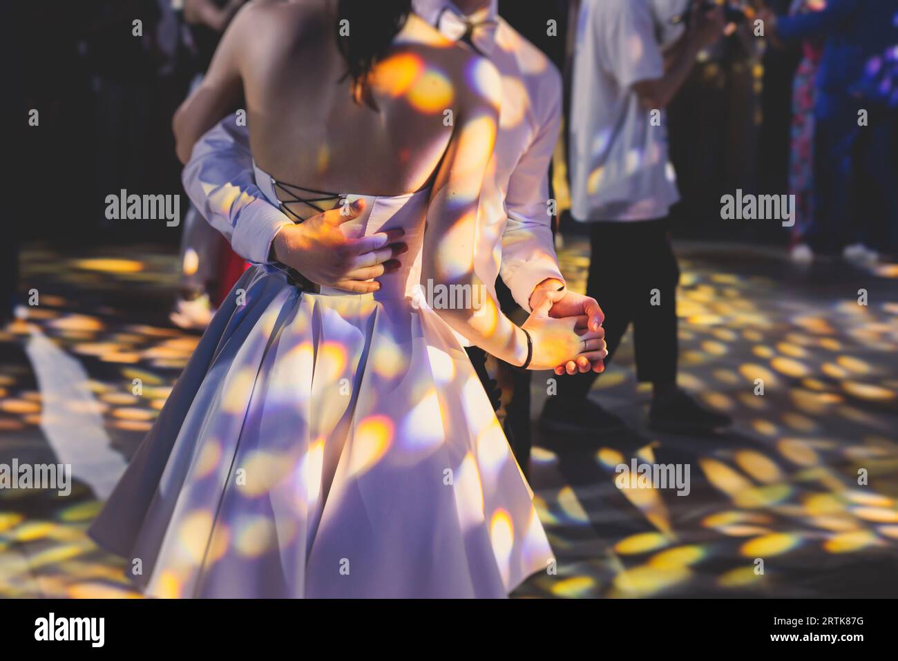 High school graduates dancing waltz and classical ball dance in dresses
